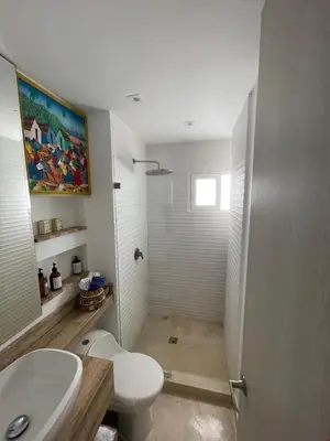 a bathroom with a toilet and a sink and a shower at Oceanfront Oasis in Cartagena de Indias