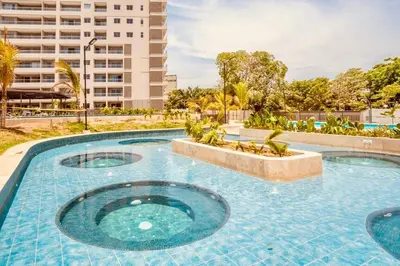 a large swimming pool with three circular pools at Apartamento Bohemio frente al Mar en Santa Marta in Santa Marta