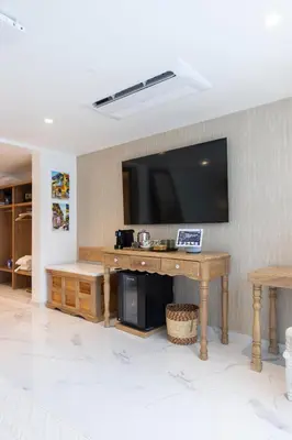 a living room with a television on a wall at Berthas collection by em hotels in Cartagena de Indias