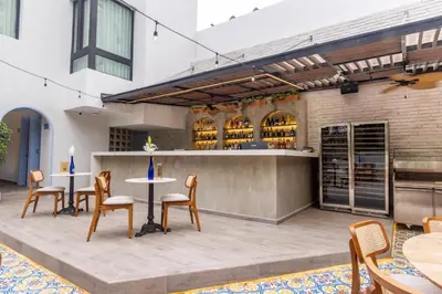 a patio with tables and chairs and a bar at Berthas collection by em hotels in Cartagena de Indias