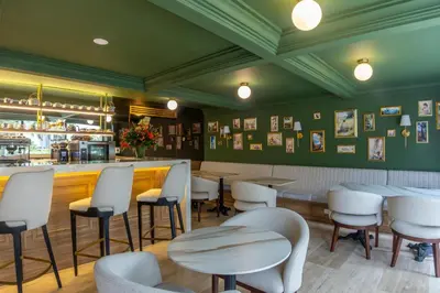 a restaurant with tables and chairs and a bar at Berthas collection by em hotels in Cartagena de Indias