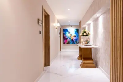 a hallway with a table and a painting on the wall at Berthas collection by em hotels in Cartagena de Indias
