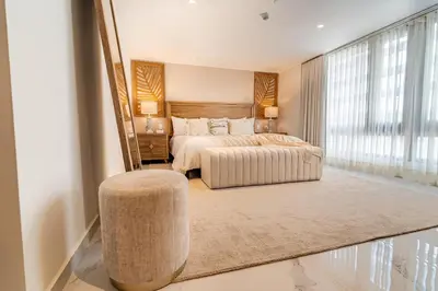 a bedroom with a bed and a large window at Berthas collection by em hotels in Cartagena de Indias