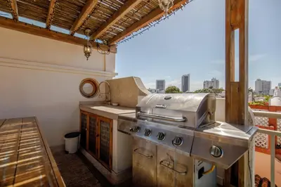 a kitchen with a stove and a balcony at Casa Stella - Authentic Luxury Rooftop Pool in Cartagena de Indias