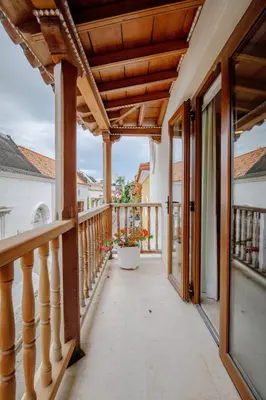 a balcony of a home with a wooden pergola at Casa Stella - Authentic Luxury Rooftop Pool in Cartagena de Indias