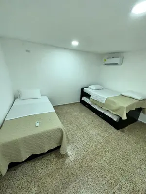 a room with two beds in a room at Hotel H&H in Cartagena de Indias
