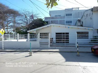 a white building on the side of a street at Hotel H&H in Cartagena de Indias