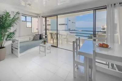 a living room with a couch and a table at Tropical Beach - Con vista al mar in Cartagena de Indias