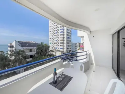 a balcony with a table and a view of the ocean at Tropical Beach - Con vista al mar in Cartagena de Indias