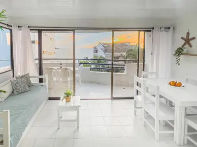 a living room with a table and a view of the ocean at Tropical Beach - Con vista al mar in Cartagena de Indias