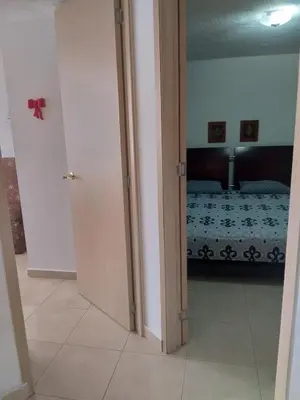 a room with a bed and a room with a door at Apartamento 3 alcobas barrio Miramar Barranquilla in Barranquilla