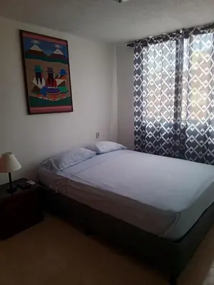 a bedroom with a bed and a window at Apartamento 3 alcobas barrio Miramar Barranquilla in Barranquilla
