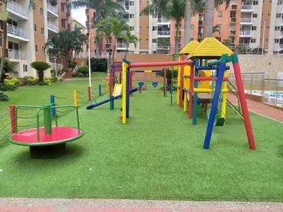 a playground with colorful play equipment in a park at Apartamento 3 alcobas barrio Miramar Barranquilla in Barranquilla