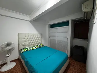 a bedroom with a blue bed and a fan at Mar azul Cartagena in Arizona