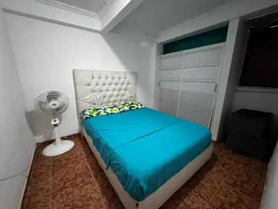 a small bedroom with a bed and a fan at Mar azul Cartagena in Arizona