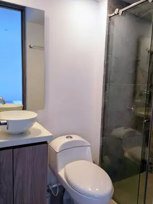 a bathroom with a toilet and a sink and a shower at Apartamento moderno cerca de la playa in Cartagena de Indias