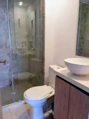 a bathroom with a toilet and a sink and a shower at Apartamento moderno cerca de la playa in Cartagena de Indias