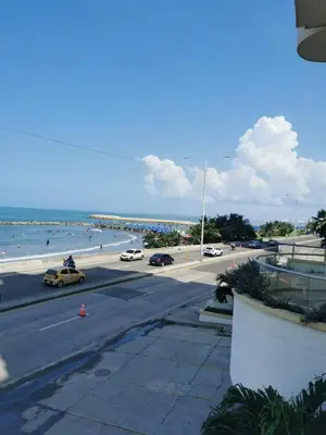 a view of a beach with cars on the road at Oceanfront apartment in Cartagena de Indias
