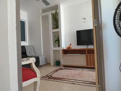 a living room with a television and a couch at Oceanfront apartment in Cartagena de Indias