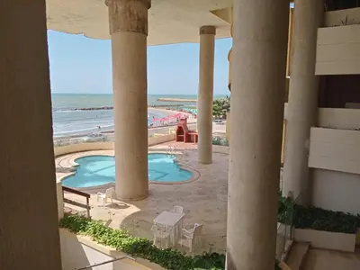a view of the beach from the balcony of a resort at Oceanfront apartment in Cartagena de Indias