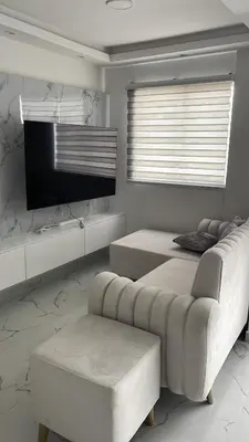 a bedroom with two beds and a couch and a television at Acuarium in Cartagena de Indias