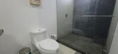 a bathroom with a toilet and a glass shower at Live Stay - Boquilla Le Solei in Cartagena de Indias