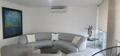 a living room with a gray couch and a table at Live Stay - Boquilla Le Solei in Cartagena de Indias