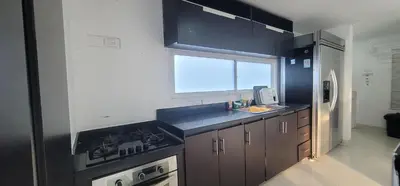 a kitchen with a stove and a sink and a window at Live Stay - Boquilla Le Solei in Cartagena de Indias