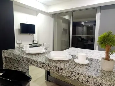 a kitchen with a counter with plates and wine glasses at Olas & relax Cartagena in Cartagena de Indias