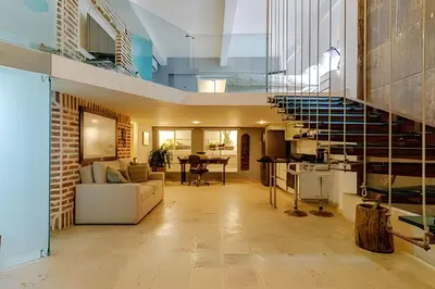 a living room with a staircase in a house at Luxury Duplex Retreat, Aldaba Selection in Cartagena de Indias
