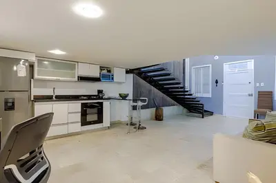 a living room with a kitchen and a staircase at Luxury Duplex Retreat, Aldaba Selection in Cartagena de Indias