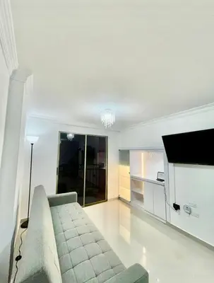 a living room with a couch and a tv at Apartment in Barranquilla in Barranquilla