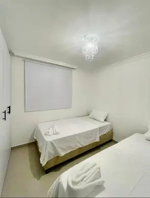 a white room with two beds and a projection screen at Apartment in Barranquilla in Barranquilla