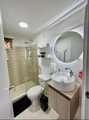 a bathroom with a sink and a toilet and a mirror at Apartment in Barranquilla in Barranquilla