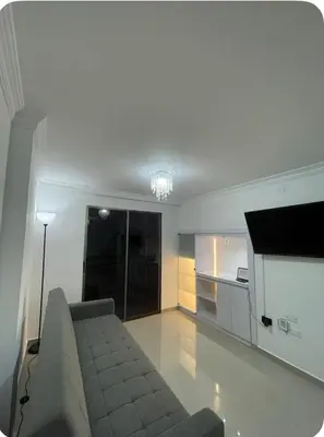 a living room with a couch and a kitchen at Apartment in Barranquilla in Barranquilla