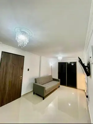 a living room with a couch and a chandelier at Apartment in Barranquilla in Barranquilla