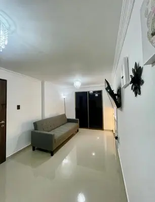 a living room with a couch and a flat screen tv at Apartment in Barranquilla in Barranquilla