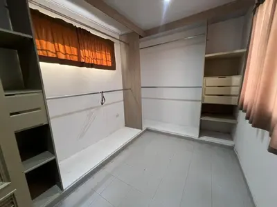 a walk in closet with a window and shelves at Casa Mansion in Barranquilla