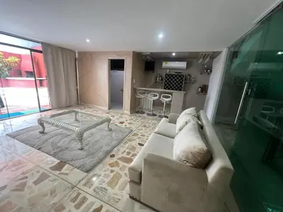 a living room with a couch and a table at Casa Mansion in Barranquilla