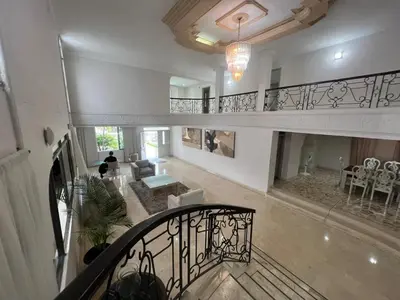 a large room with a staircase and a living room at Casa Mansion in Barranquilla