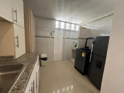 a small kitchen with a sink and a refrigerator at Luz in Barranquilla
