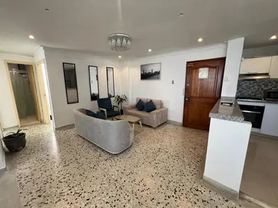 a living room with a couch and a table at Luz in Barranquilla