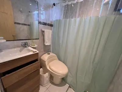 a bathroom with a toilet and a shower and a sink at Luz in Barranquilla