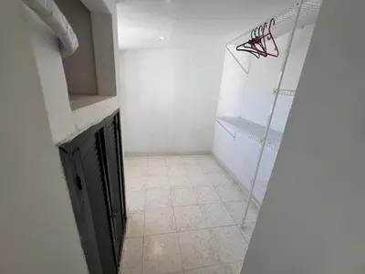 a bathroom with a walk in shower and a tiled floor at Luz in Barranquilla