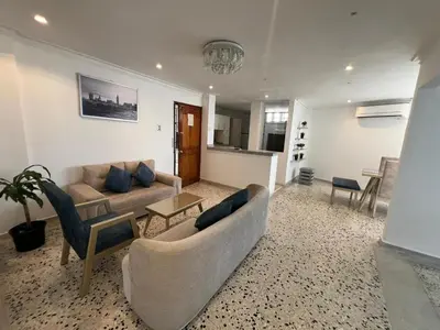 a living room with a couch and a table at Luz in Barranquilla