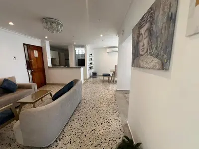 a living room with a couch and a table at Luz in Barranquilla