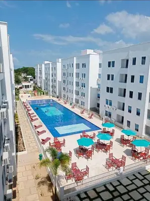 an overhead view of a swimming pool with chairs and umbrellas at Acogedor apto en Coveñas 401 in Coveñas