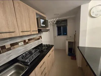 a kitchen with a sink and a stove top oven at Acogedor apto en Coveñas 401 in Coveñas