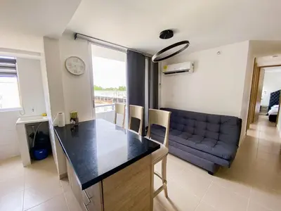 a kitchen and a living room with a couch at Acogedor apto en Coveñas 401 in Coveñas