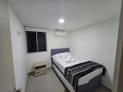 a small bedroom with a bed and a window at Acogedor apto en Coveñas 204 in Coveñas
